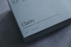 Morning-supplement. A close-up angled shot of a light blue-gray product box labeled 'Clarity' with smaller text reading 'A food supplement to support, your fibre intake, immunity & bones' and 'HINT + 30 SACHETS'.
