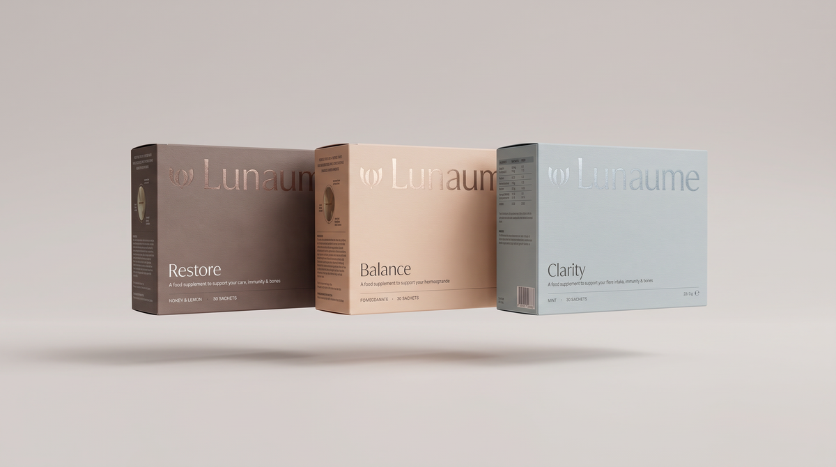Three product boxes for 'for Lunaume' arranged in a row against a neutral light gray background. The boxes are labeled 'Restore', 'Balance', and 'Clarity' in brown, beige, and light blue tones respectively.